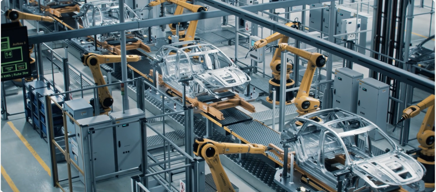 Robotic arms assembling car bodies on an automated production line